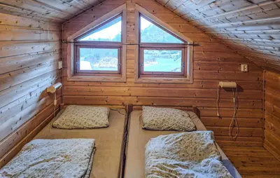 a room with two beds in a wooden cabin at Lovely Home In Masfjordnes With Sauna in Masfjorden