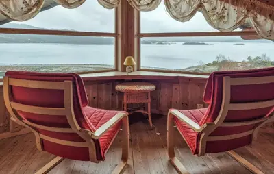 two chairs sitting in a room with a window at Lovely Home In Masfjordnes With Sauna in Masfjorden