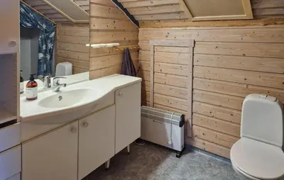 a bathroom with a sink and a toilet at Cozy Home In Masfjordnes With Sauna in Masfjorden