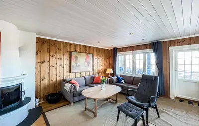 a living room with a couch and a table at Stunning Apartment In Røn With Sauna in Ron