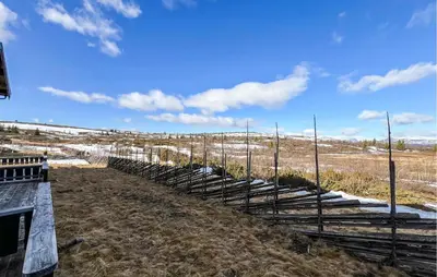a fence on the side of a field with snow at Stunning Apartment In Røn With Sauna in Ron