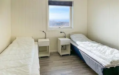 two beds in a room with a window at Nice Home In Kverva With Wifi in Kverva