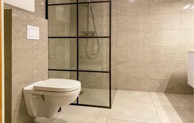 a bathroom with a toilet and a shower at Nice Home In Kverva With Wifi in Kverva