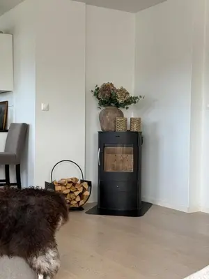 a living room with a black stove in a room at Apartment in Bergen in Bergen
