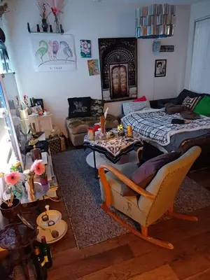 a living room with a table and a couch at Sentrums nærsentrum tur og sjø på hundvåg in Lii