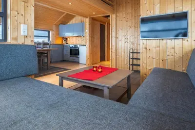 a living room with a table and a kitchen at Liapark in Ål