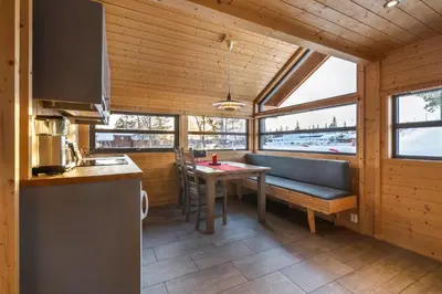 a kitchen with a table and a bench in a room at Liapark in Ål