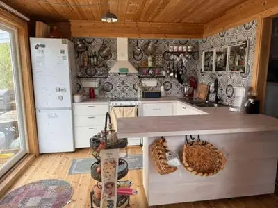 a kitchen with a counter top and a refrigerator at Seaside Cabin with panoramic view in Bømlo