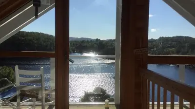 a view of a lake from a porch at Stay where the mountains begin in Bømlo