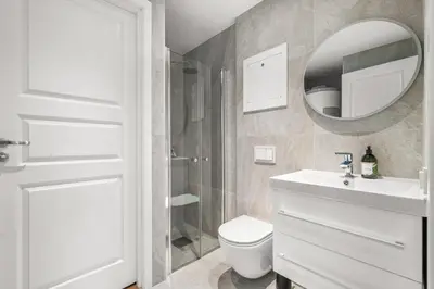 a bathroom with a toilet and a sink and a mirror at BRAND NEW! Bergen Beds Apartments I Cozy Corner in Bergen