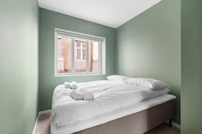 a bed in a room with a window at BRAND NEW! Bergen Beds Apartments I Cozy Corner in Bergen