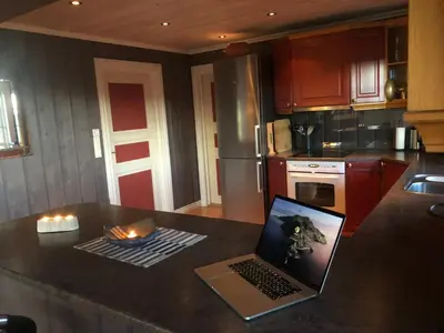 a kitchen with a laptop sitting on a counter at Skeitunet in Svingvoll