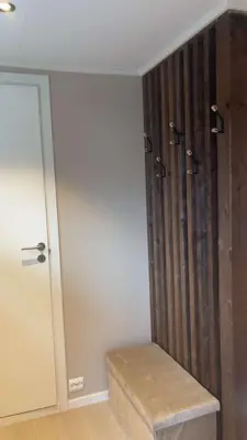 a bathroom with a shower with a wooden wall at Leilighet på Harøya in Ålesund