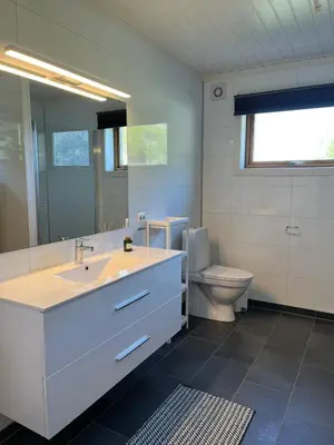 a bathroom with a sink and a toilet at Flo Lake House in Stryn