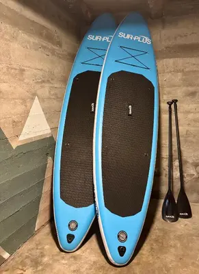 a blue surfboard sitting on top of a table at Flo Lake House in Stryn