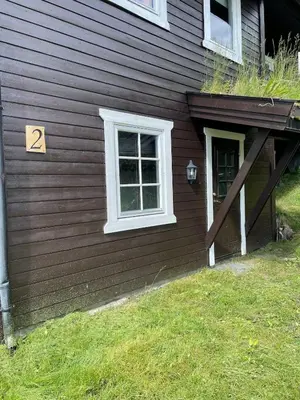 a brown house with a door and a window at 3 Bedroom Apartment with nice view by Gaustatoppen in Gaustablikk