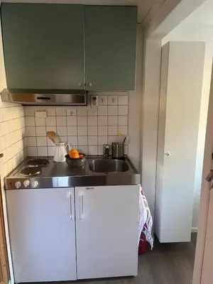 a kitchen with a sink and a counter top at Leilighet i Lillehammer med gratis parkering in Lillehammer