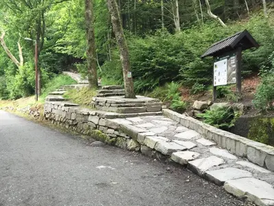 a stone wall on the side of a road at Nice apartment in modern complex near Old Bergen in Bergen