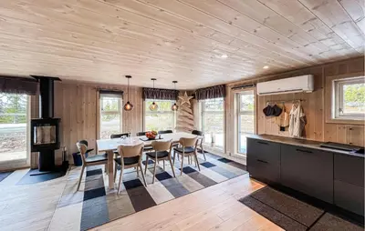 a kitchen and dining room with a table and chairs at Stunning Home In Sjusjøen With Sauna in Sjusjøen