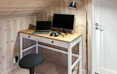 a desk with a laptop and a computer monitor on it at Stunning Home In Sjusjøen With Sauna in Sjusjøen