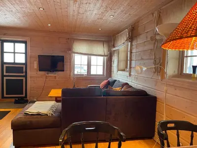 a living room with a couch and a tv at Syndinstøga in Ryfoss
