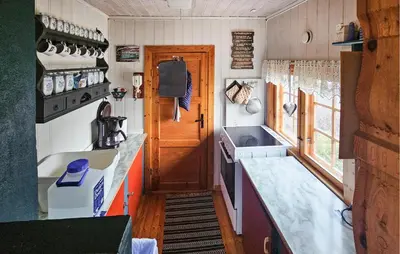 a small kitchen in a tiny house with a sink at 4 Bedroom Amazing Home In Rødberg in Rødberg