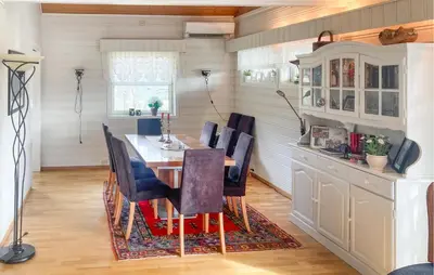 a dining room with a table and chairs at 4 Bedroom Nice Home In Flornes in Flornes