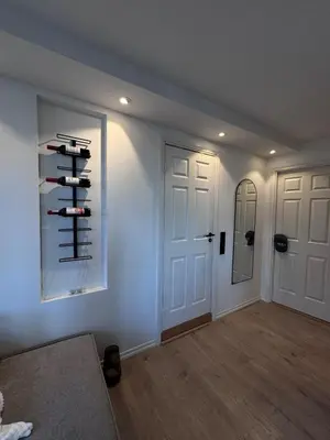 a living room with wine bottles on a wall at Sental apartment in Sandviken in Bergen