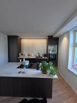 a kitchen with a large island in the middle at Sental apartment in Sandviken in Bergen
