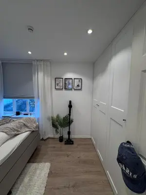 a bedroom with a bed and a window at Sental apartment in Sandviken in Bergen