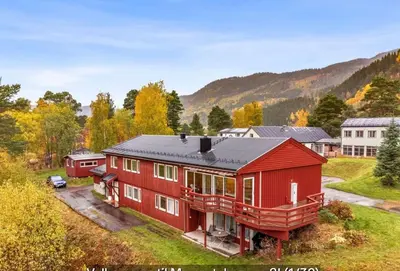 an aerial view of a red house in a field at Small apartment in Meldal in Syrstad