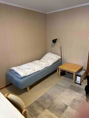a small room with a bed and a table at Small apartment in Meldal in Syrstad