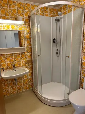 a bathroom with a shower and a sink at Small apartment in Meldal in Syrstad