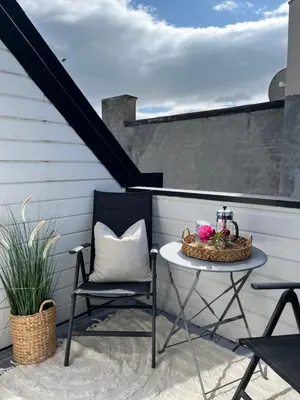 a patio with a table and chairs and a staircase at The Jugend Loft in Ålesund