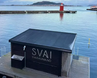 a black box sitting on a dock in the water at The Jugend Loft in Ålesund