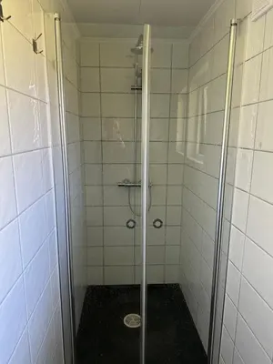 a shower with a glass door in a bathroom at Maria apartment with Sauna Otta in Otta