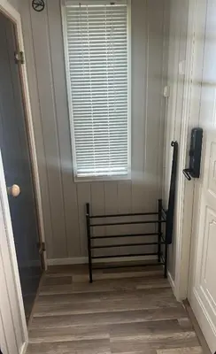 a hallway with a window and a bed in a room at Maria apartment with Sauna Otta in Otta