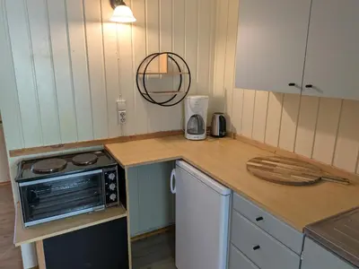 a kitchen with a counter top with a microwave at Myrland Apartments in Hovet