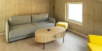 a living room with a couch and a coffee table at Near-Sea Boat House With Panoramic Views in Sykkylven