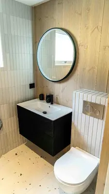 a bathroom with a sink and a toilet and a mirror at Near-Sea Boat House With Panoramic Views in Sykkylven