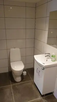 a bathroom with a toilet and a sink at Studio apartment 48m2 in Hølera