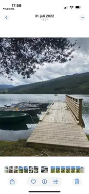 a photo of a dock and a boat on a lake at Hafslo hytteutleige Straumane in Hafslo