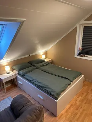 a bedroom with a bed and a window and a couch at Comfortable room - Double bed - Private bathroom - Free parking - Shared kitchen - Bus stop and store 2 min walk in Lunden