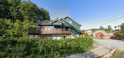 a green house sitting on the side of a street at Comfortable room - Double bed - Private bathroom - Free parking - Shared kitchen - Bus stop and store 2 min walk in Lunden