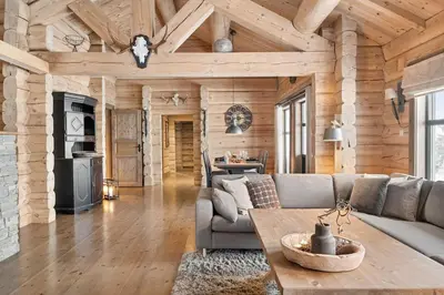 a living room with a couch and a table at Large and cozy family cabin with sauna in Trysil
