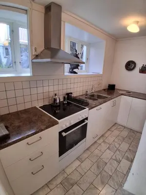 a kitchen with a sink and a stove top oven at Appartement calme et central sur Bergen in Bergen