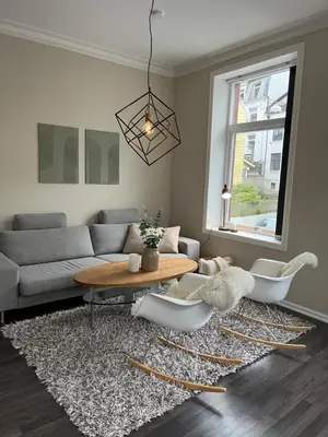 a living room with a couch and a table at Nouveau Nook in Ålesund