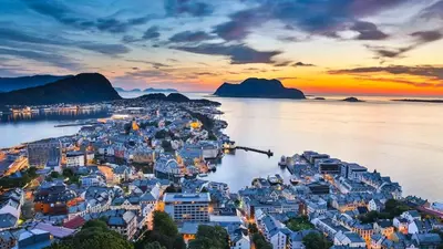 an aerial view of a town on the water at sunset at Nouveau Nook in Ålesund