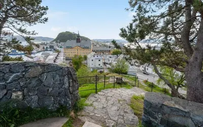 a view of a town from a hill with trees at Nouveau Nook in Ålesund
