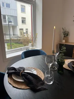 a table with a black napkin and glasses and a window at Nouveau Nook in Ålesund
